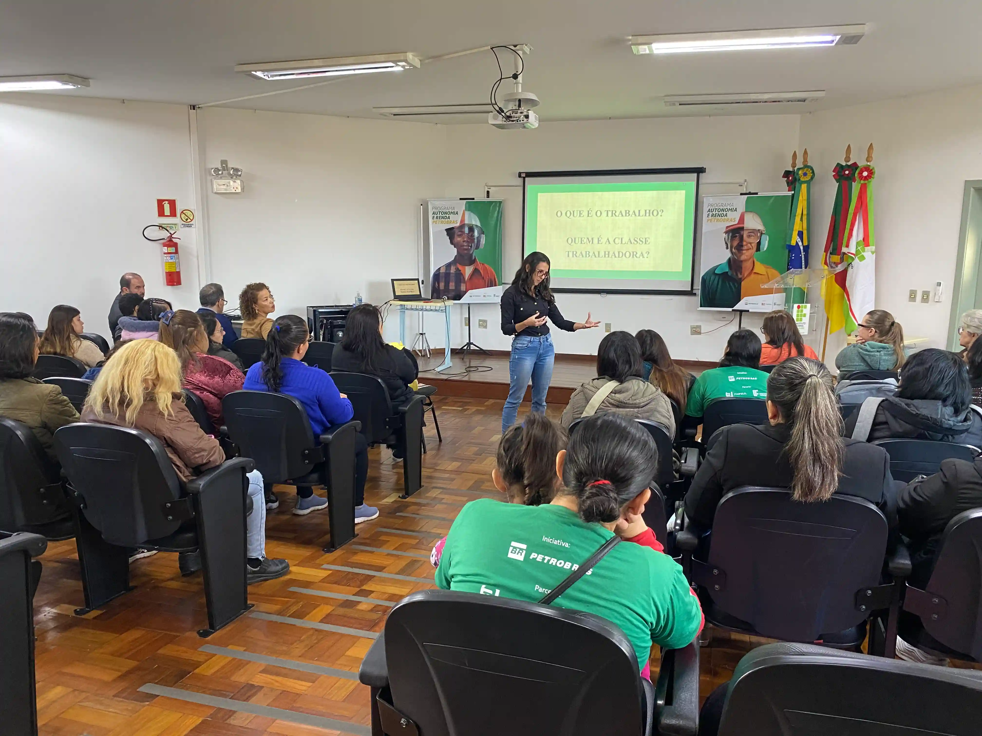 Imagem de estudantes do Programa Autonomia e Renda Petrobras em auditório do IFRS assistindo a uma palestra.